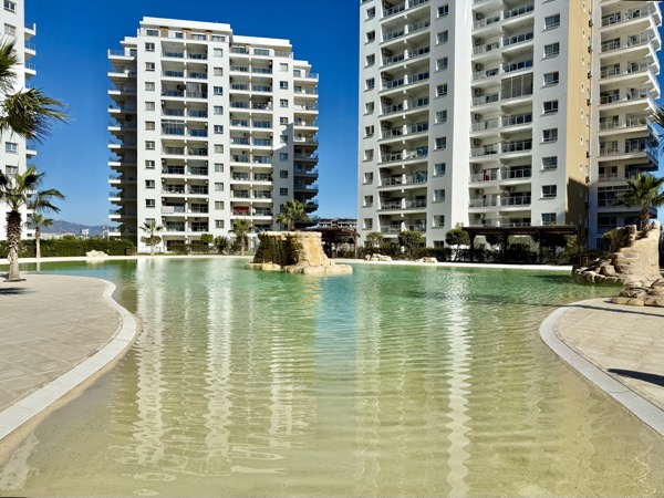 Lagoon-style pool with sandy bottom
