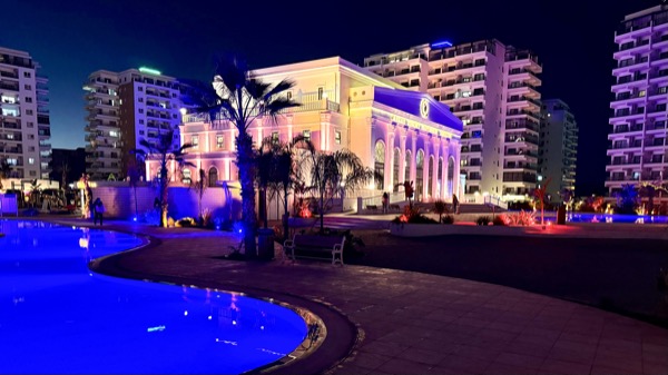 Resort palace and pool at night