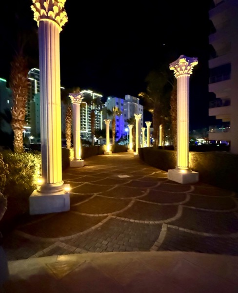 Golden-lit Corinthian columns at night