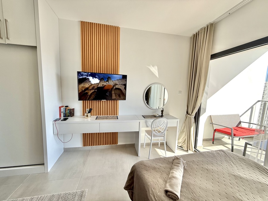 Bedroom with TV and vanity