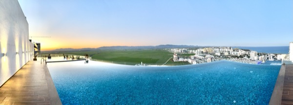 Rooftop infinity pool panorama at sunset