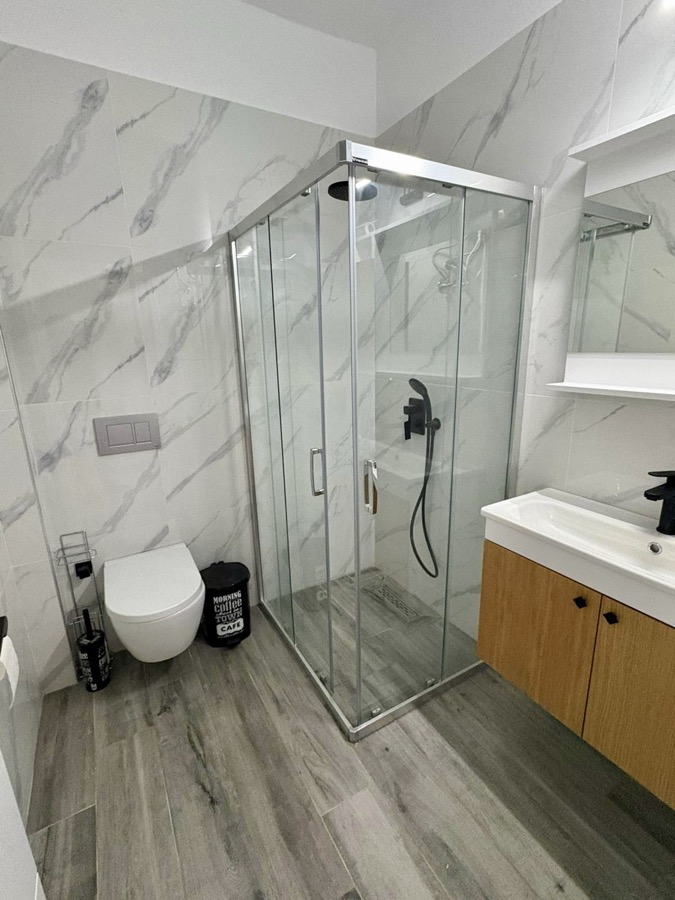 Modern bathroom with marble tiles and shower