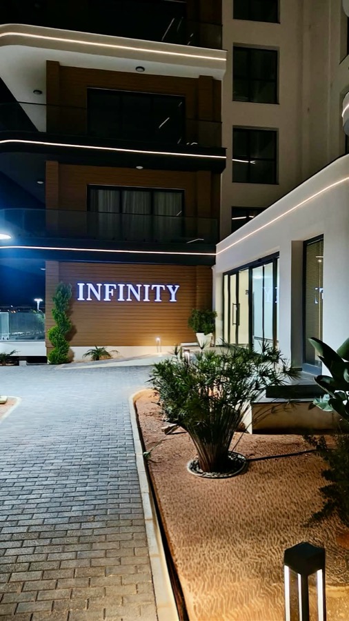 Illuminated Infinity sign at the residence entrance