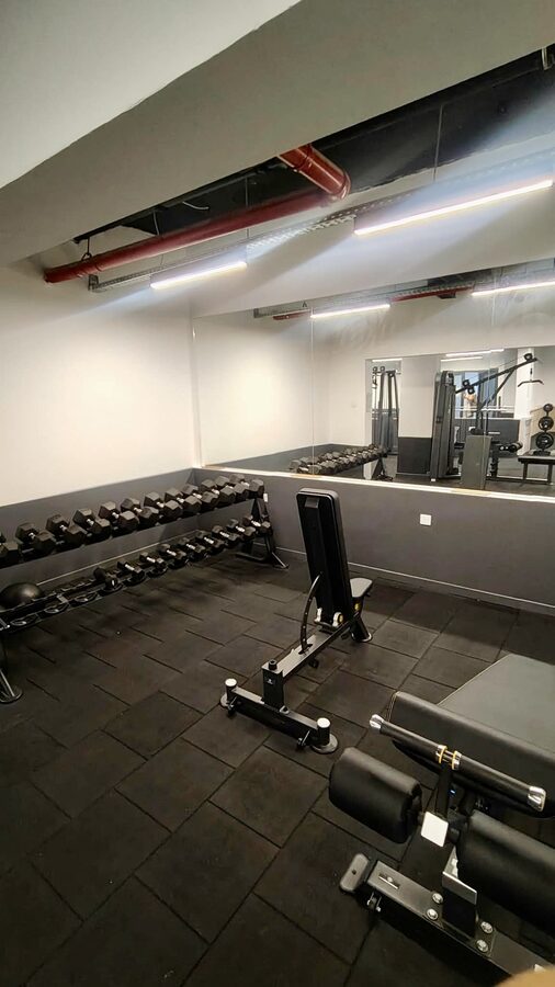 Residents' gym with free weights and machines