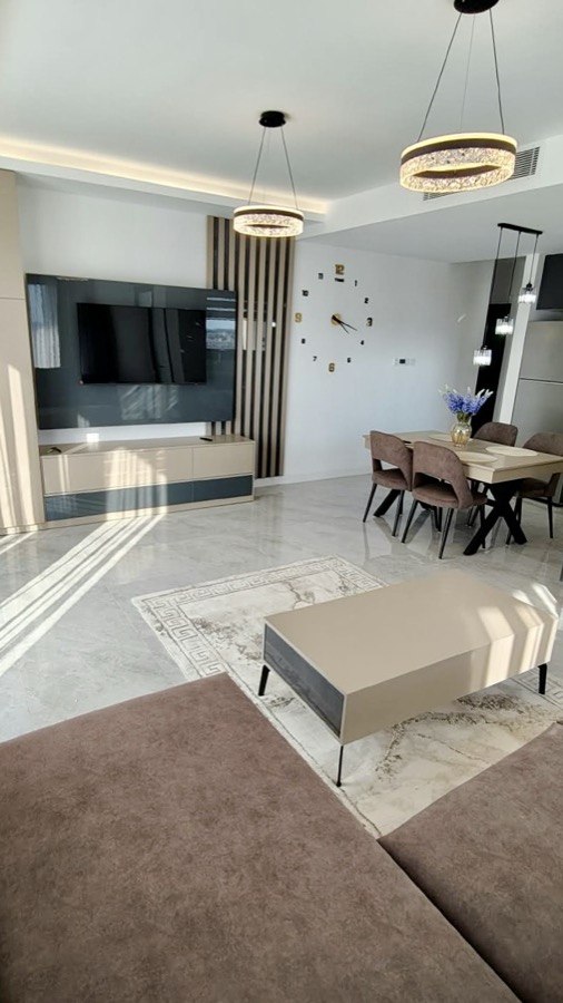 Lounge with corner sofa, TV wall and dining area