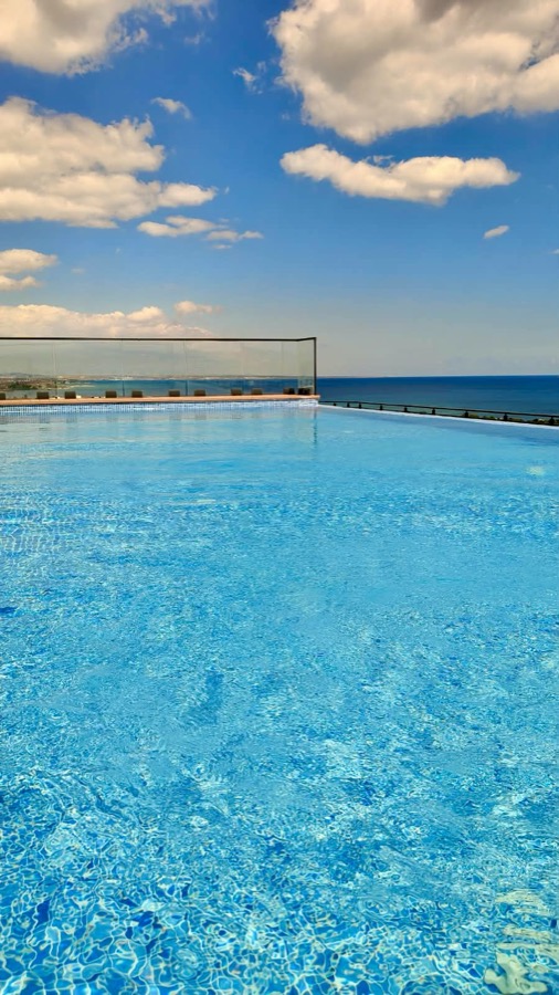 Rooftop infinity pool meeting the Mediterranean horizon