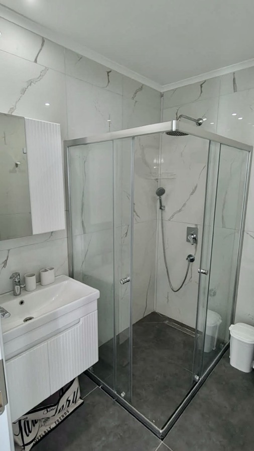 Bathroom with glass shower cabin and rain shower